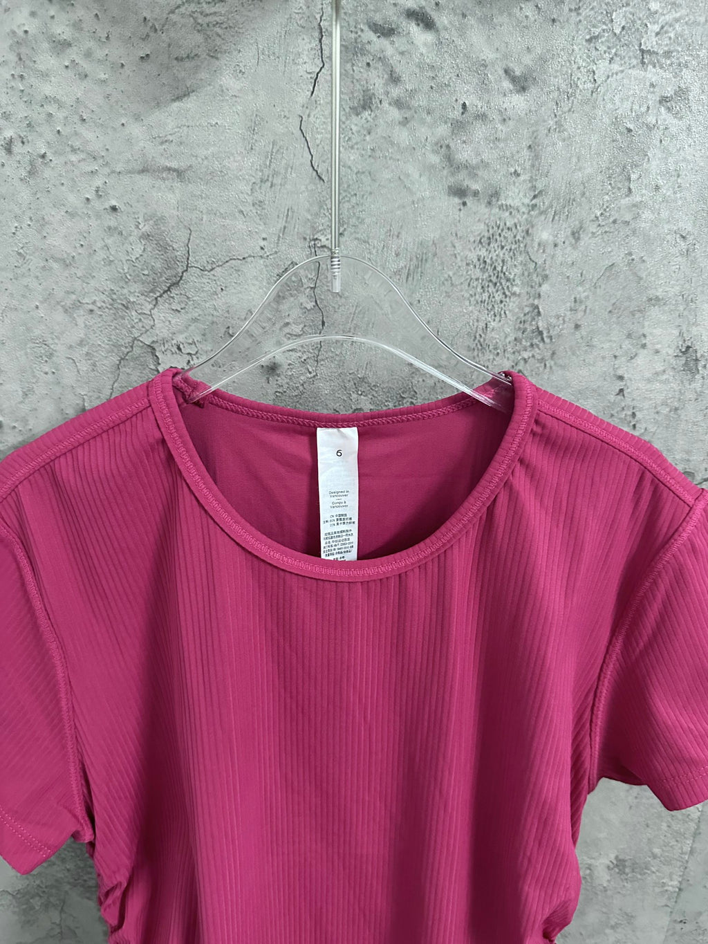 Pink ribbed crew-neck T-shirt neckline with inner neck tag