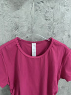 Pink crewneck short-sleeve top with ribbed knit and round neckline
