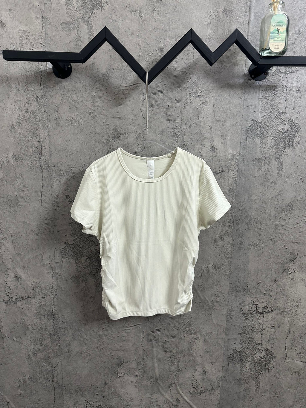 Off-white crew-neck T-shirt with short sleeves and ribbed texture