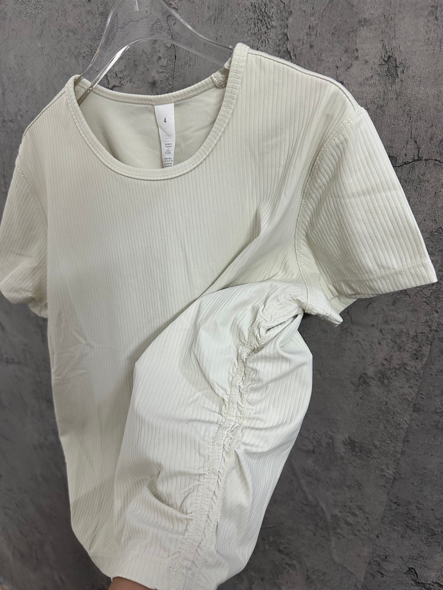 Cream ribbed T-shirt with crew neck and sleeve close-up