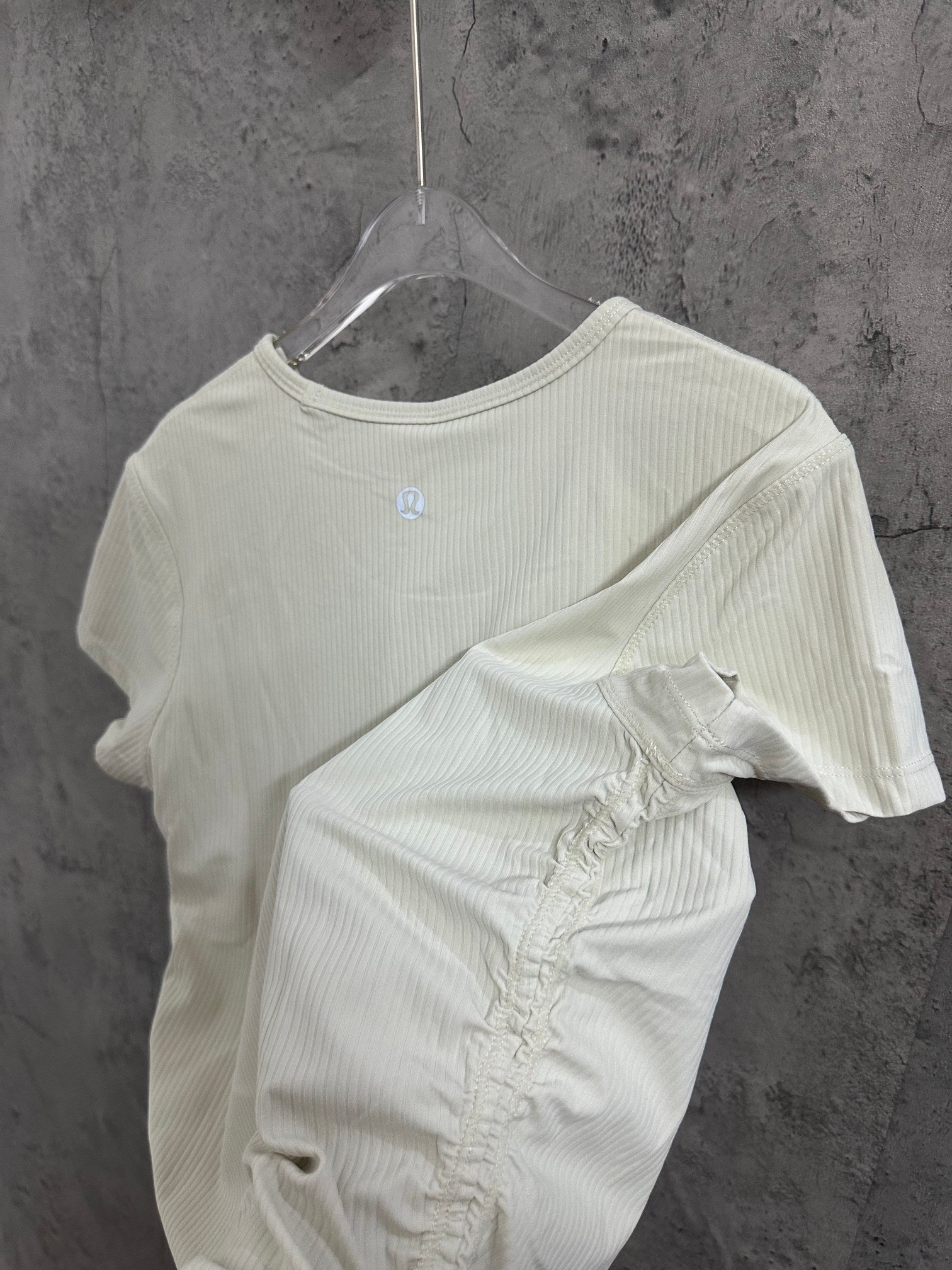 Cream ribbed T-shirt with small chest logo and folded detail