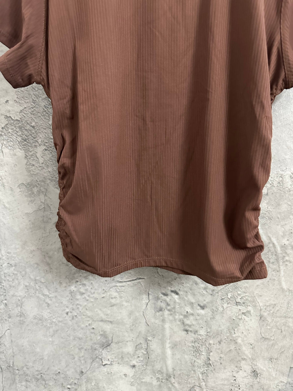 Brown ribbed short-sleeve T-shirt back view on hanger