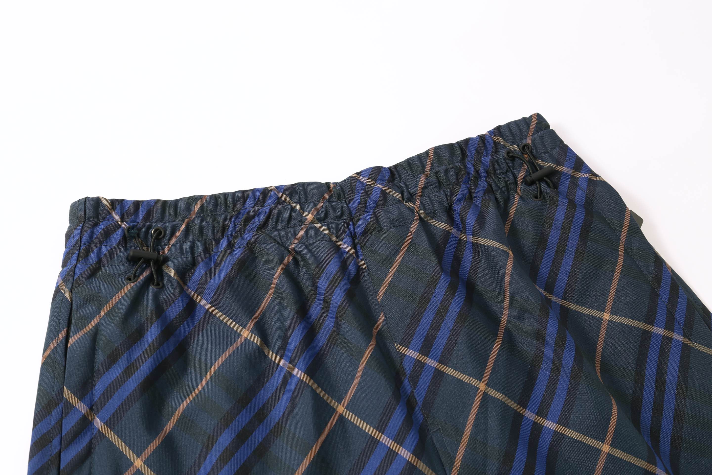 Plaid shorts waistband with elastic, drawstring ties, and gathered trim