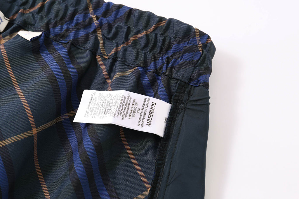Plaid shorts with elastic waistband and product label tag