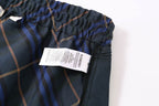 Plaid shorts with elastic waistband and product label tag