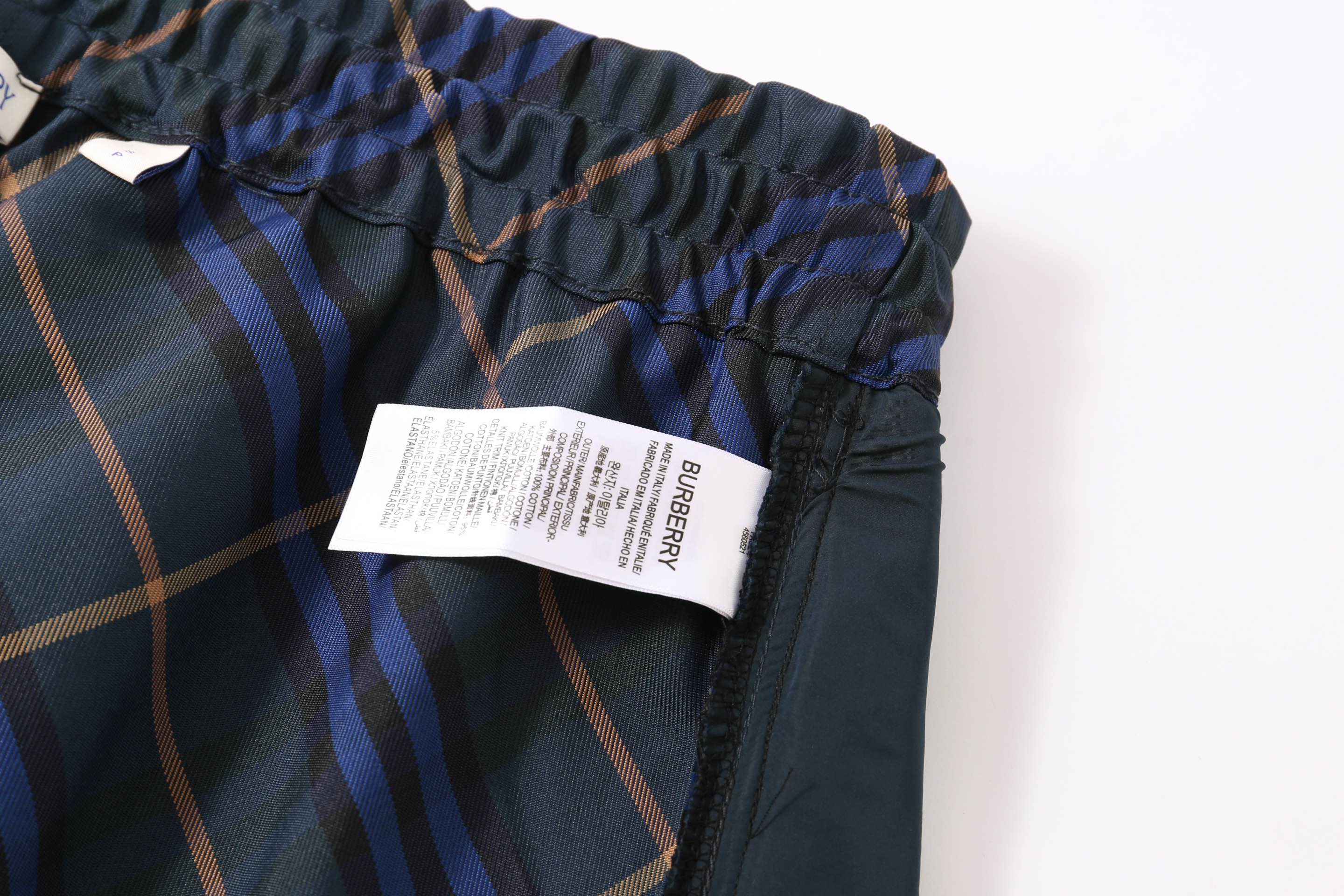 Plaid shorts with elastic waistband and product label tag
