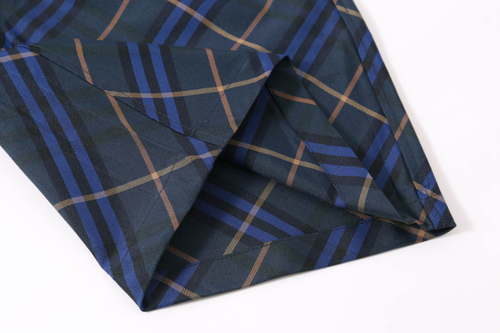 Navy plaid shorts fabric with diagonal pleats at the hem