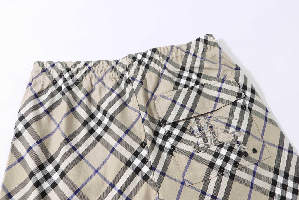 Burberry check plaid shorts, beige with black and blue; front view with drawstring