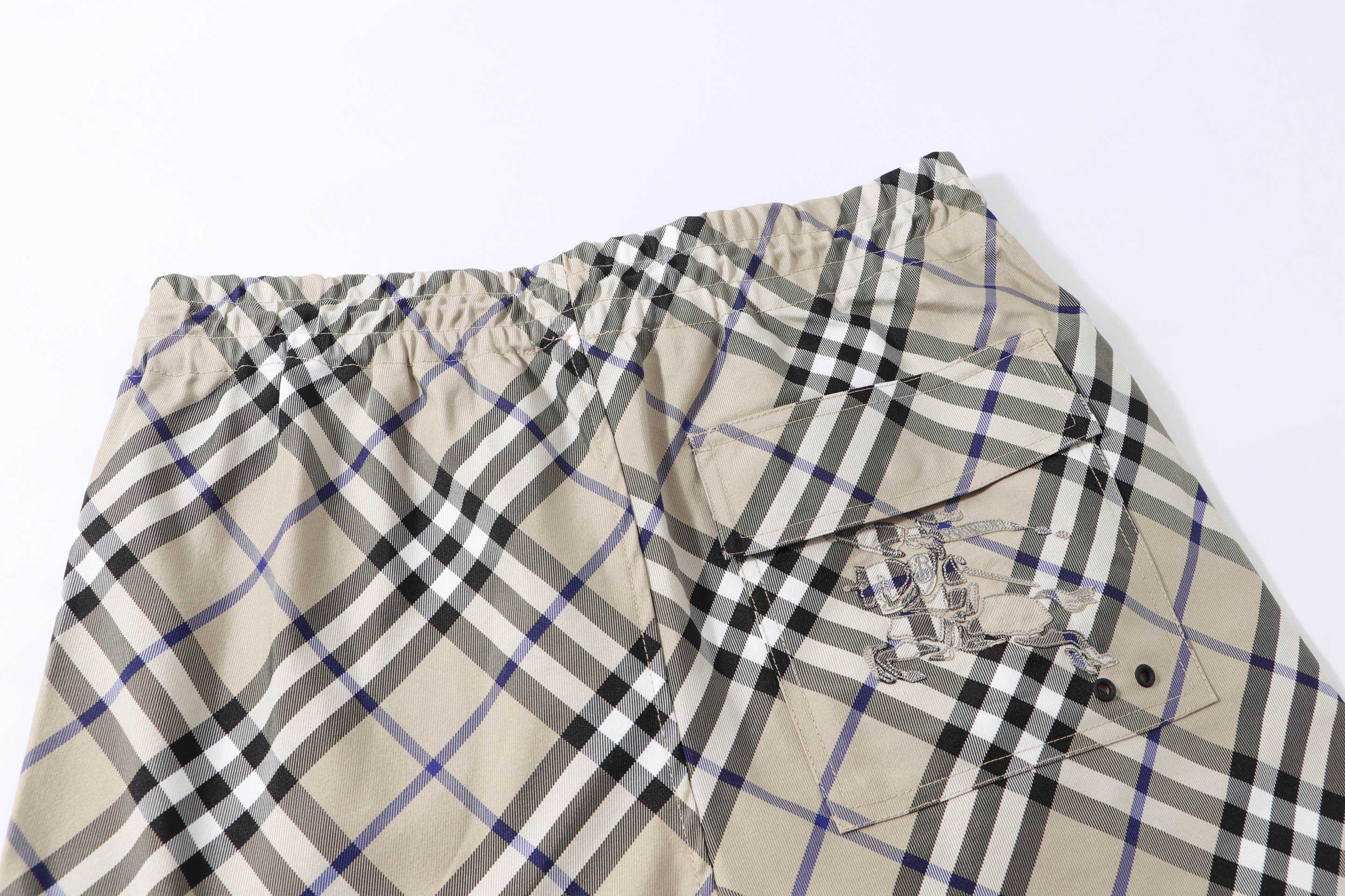 Burberry check plaid shorts, beige with black and blue; front view with drawstring