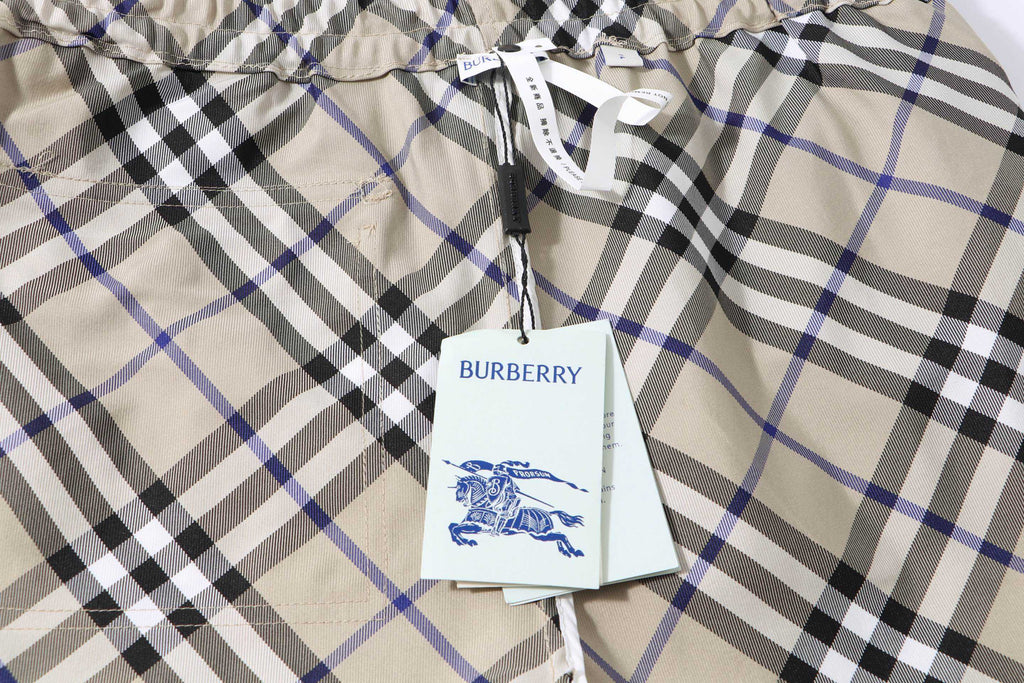 Burberry check plaid shorts fabric with brand tag hanging from the waistband