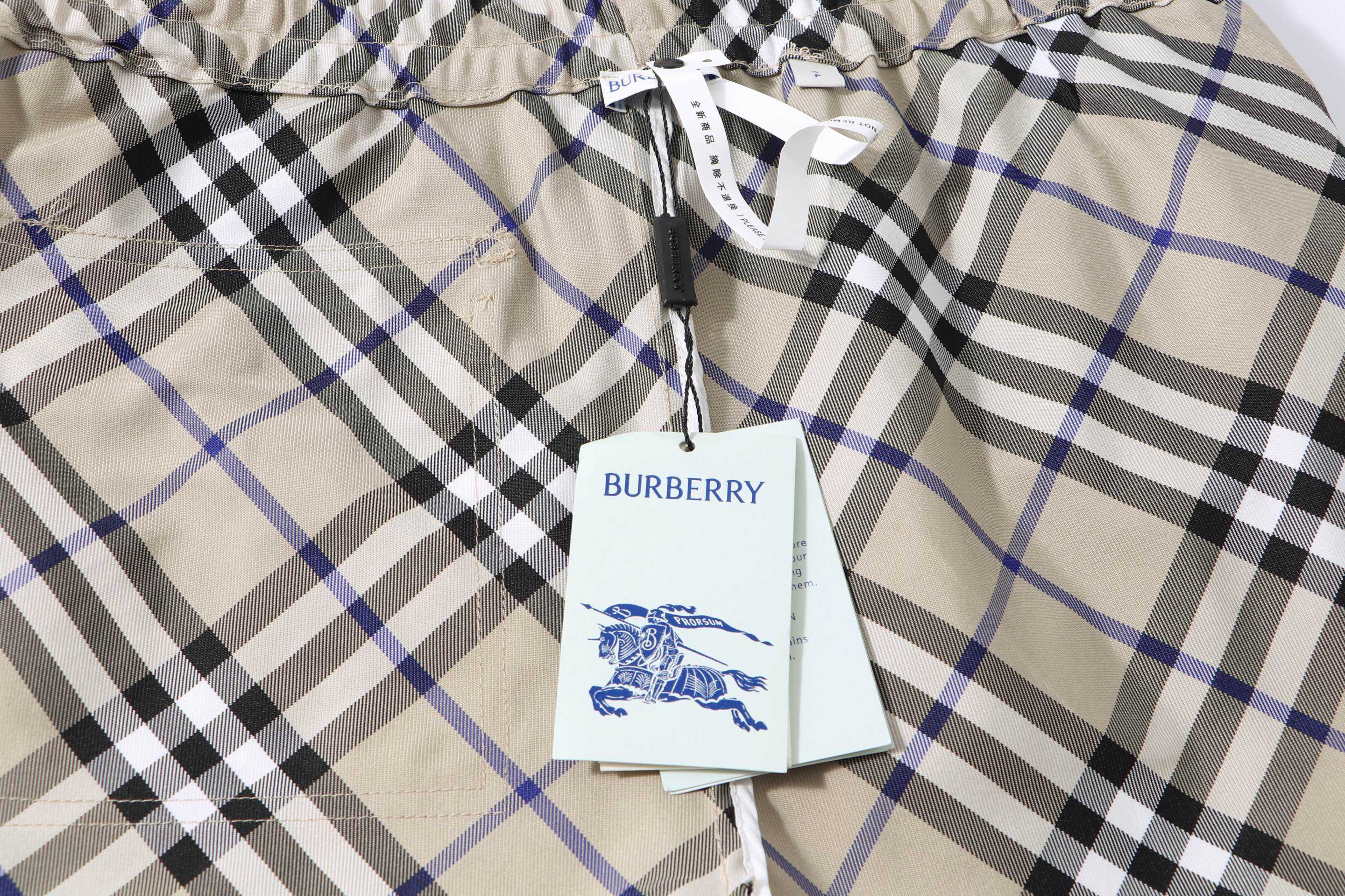 Burberry check plaid shorts fabric with brand tag hanging from the waistband