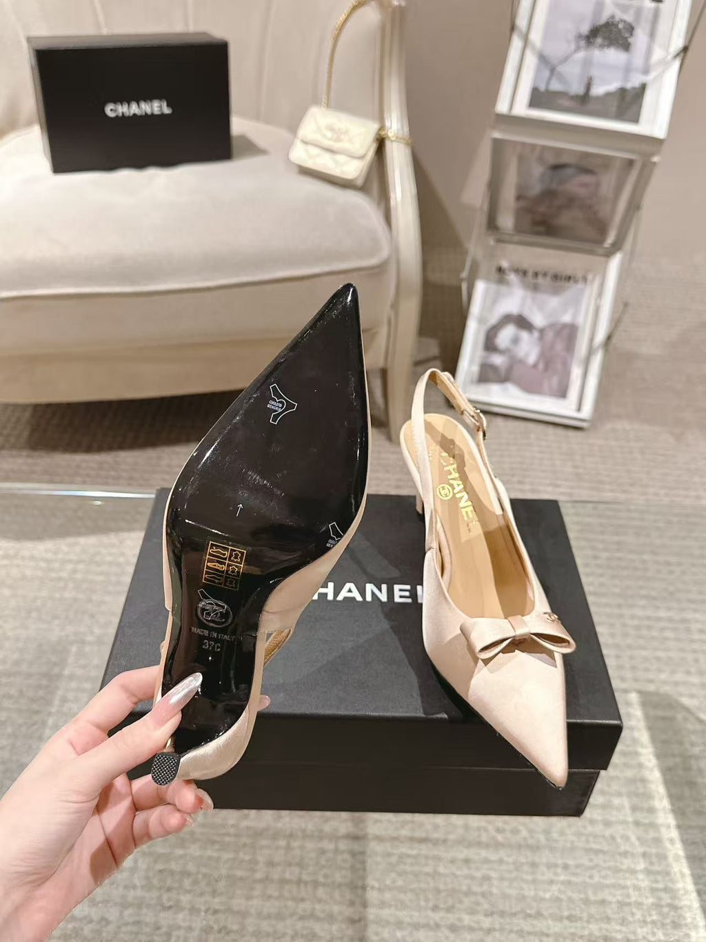 Women's pointed-toe slingback heels in black and beige with bow accents on box