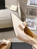Women's beige pointed-toe slingback heel with bow detail and open heel counter