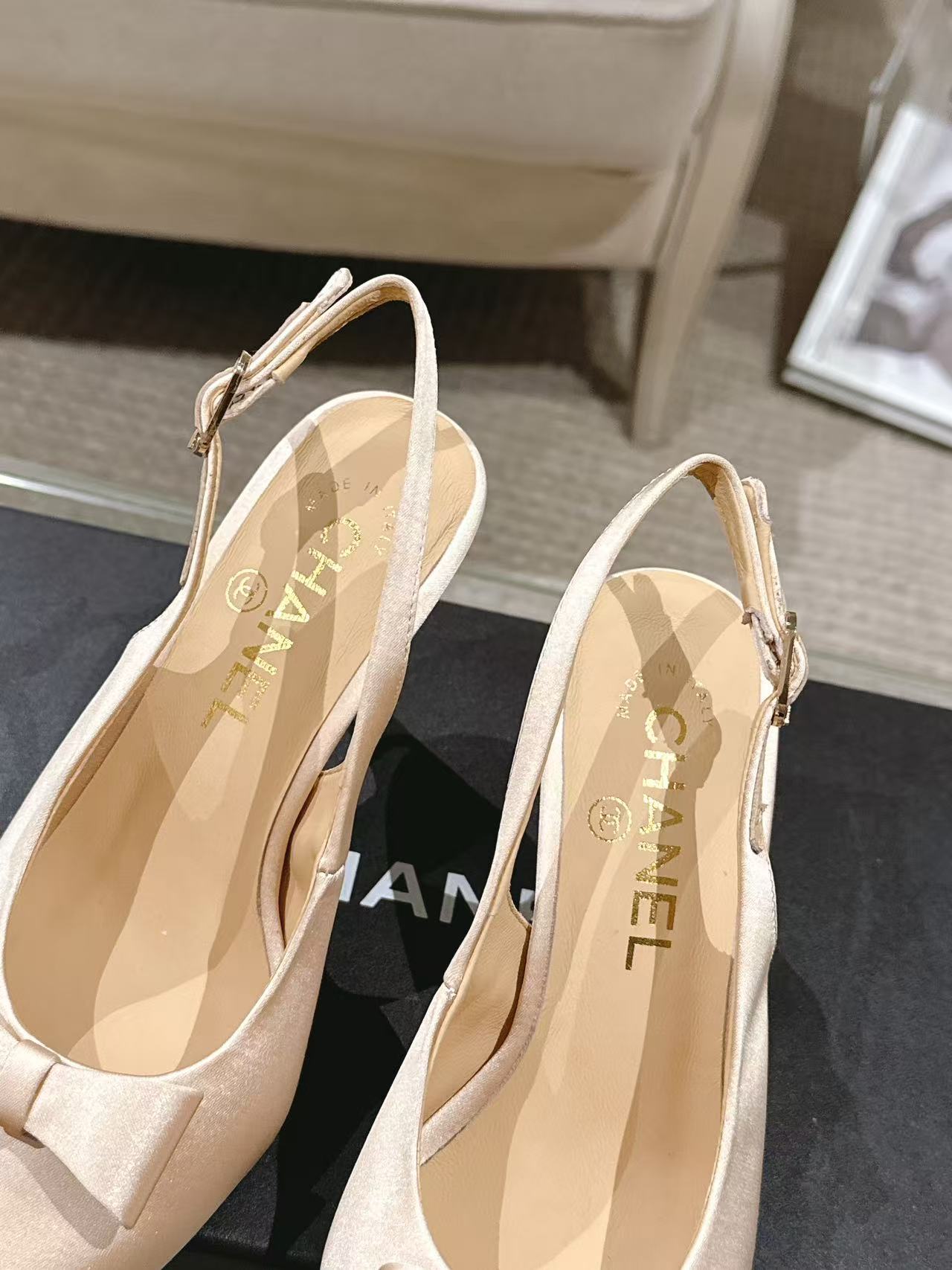 Women's beige slingback heels showing interior lining and 'CHANEL' insole