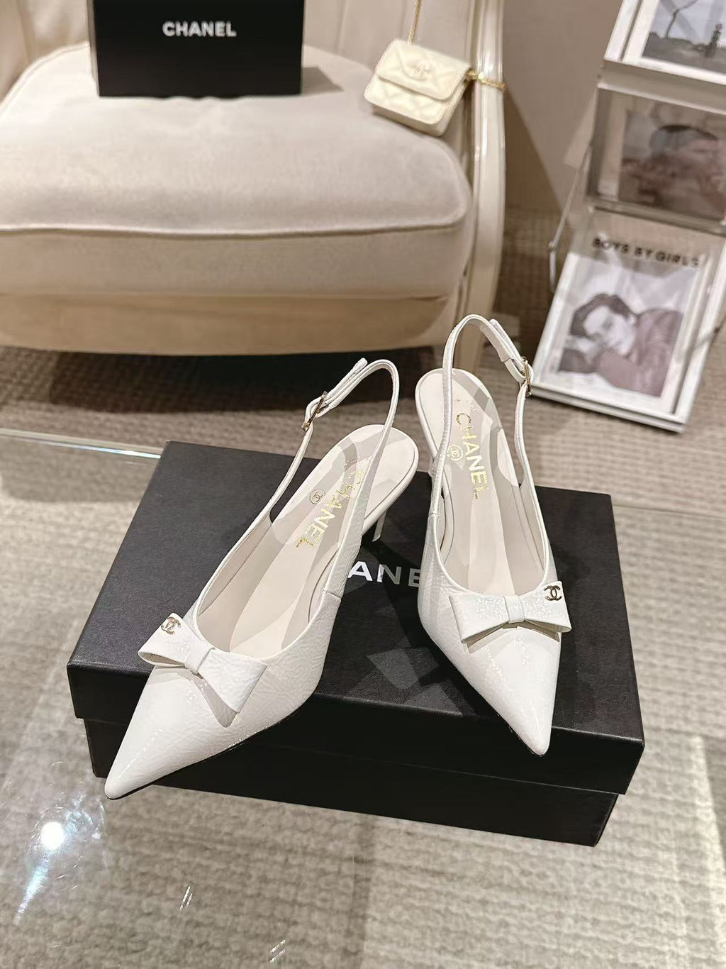 White pointed-toe slingback pumps with bow strap and slim black heel