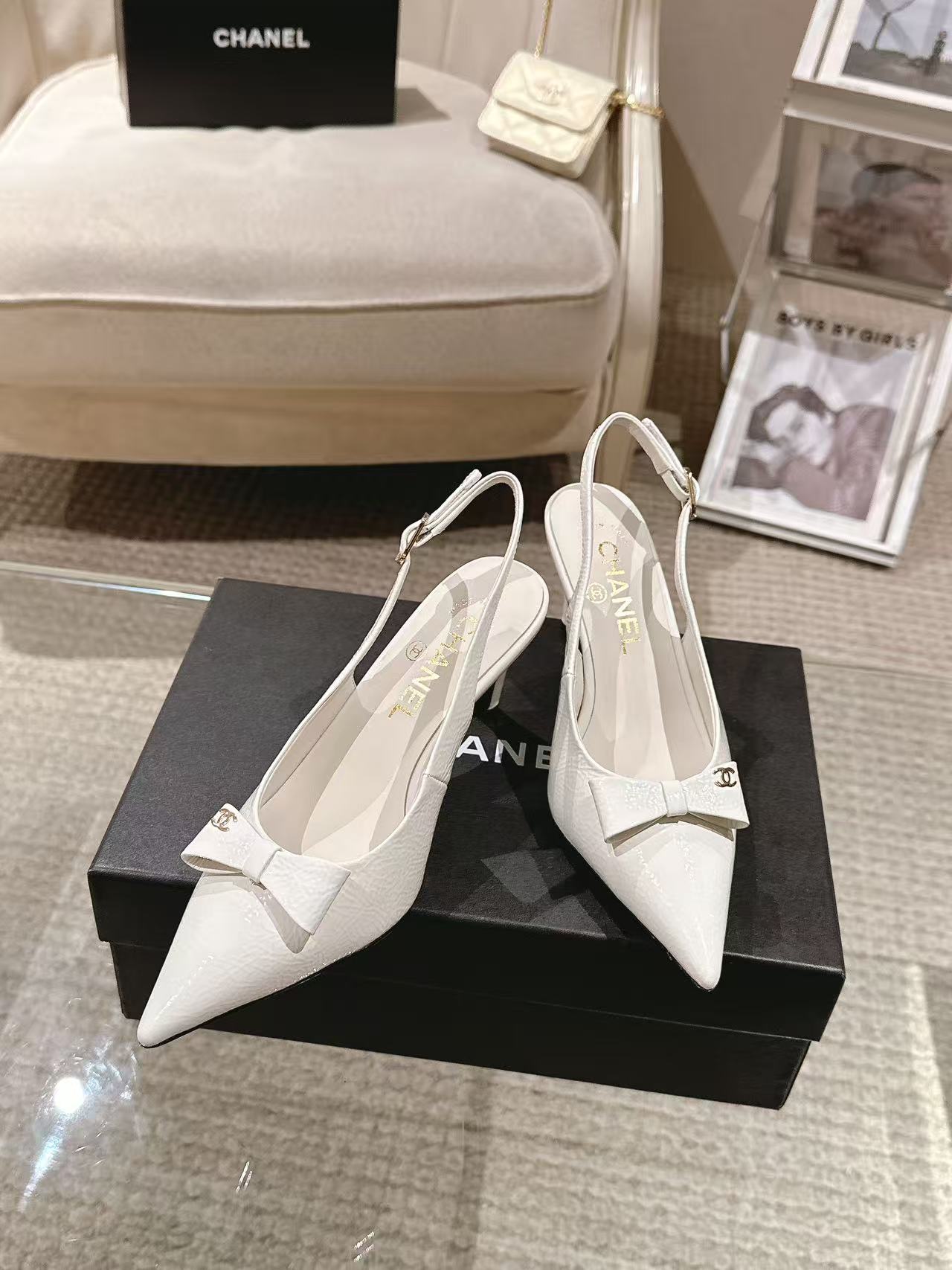 White pointed-toe slingback pumps with bow strap and slim black heel