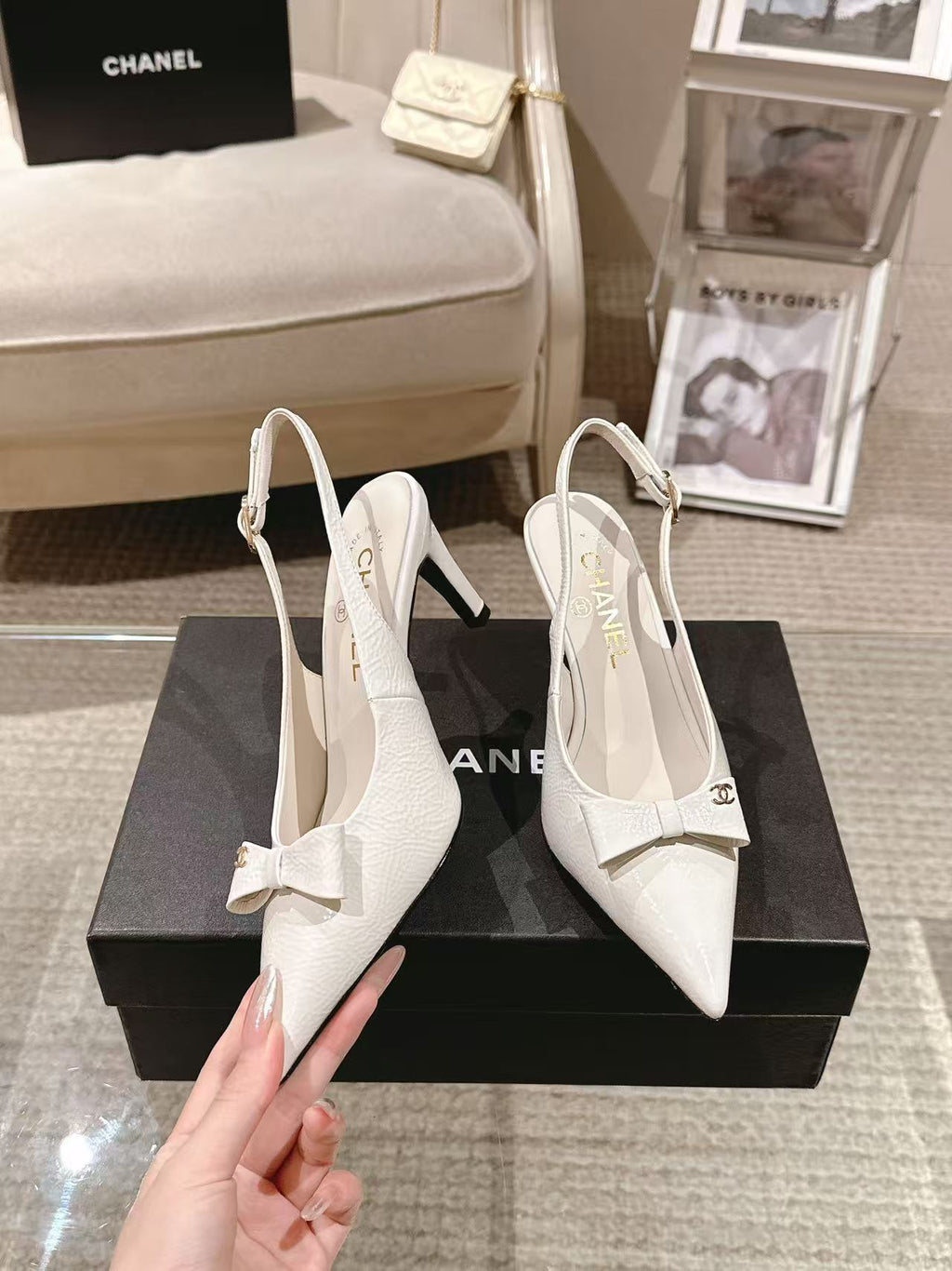 White pointed-toe slingback pumps with bow strap and slim black heel