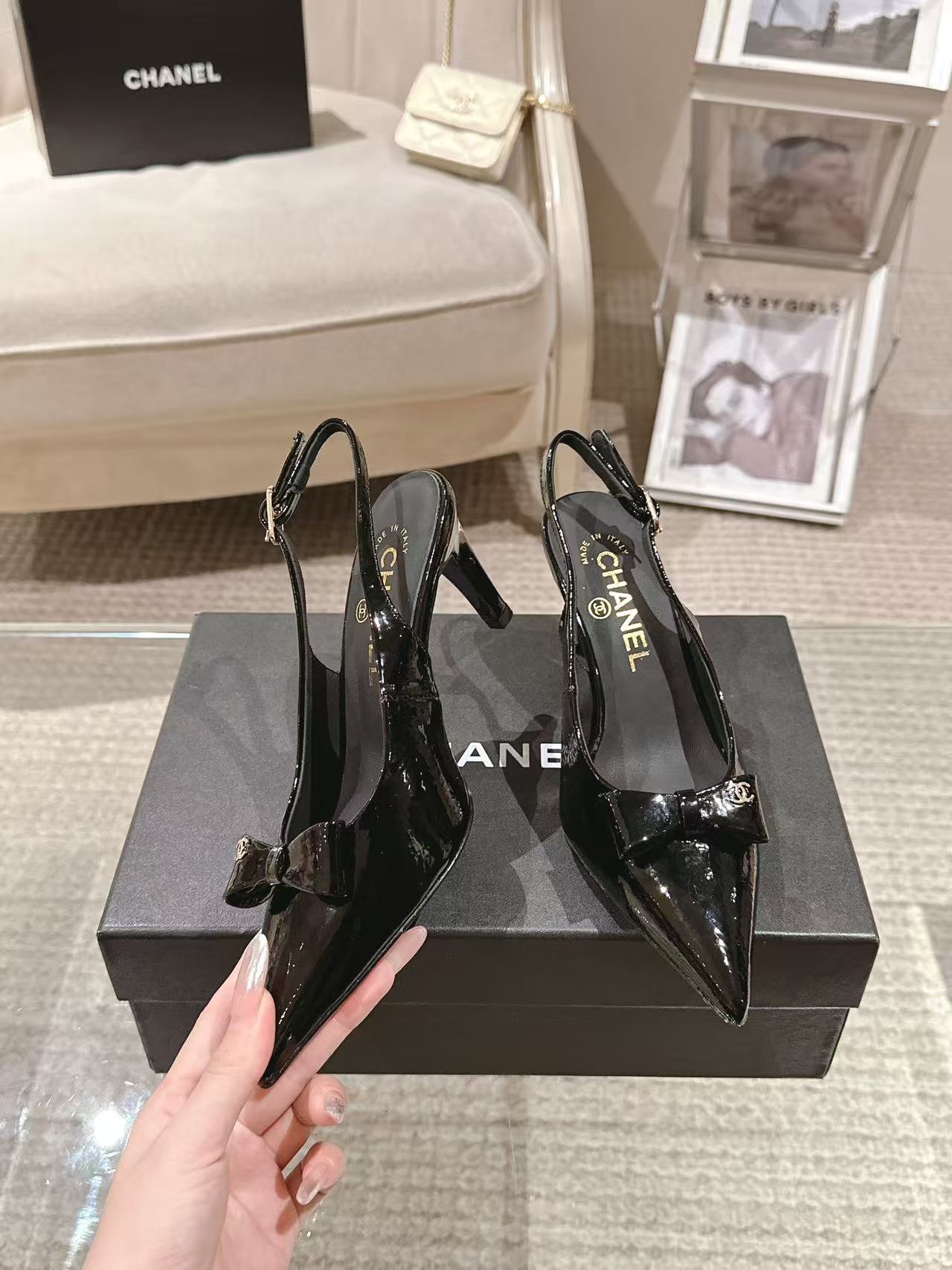 Chanel black patent slingback pumps with pointed toe and bow detail, heel view