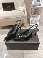 Chanel black patent slingback pumps with pointed toe and low heel, side view