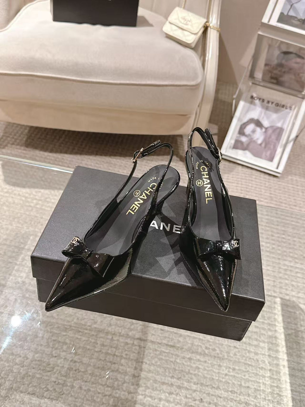 Chanel black patent pointed-toe pumps with slingback strap and bow detail