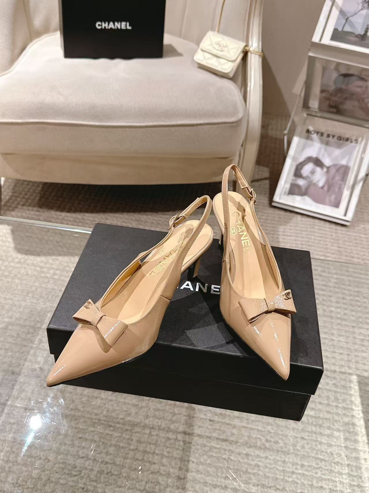 Women’s beige pointed-toe pumps with bow-tie slingback strap, glossy finish