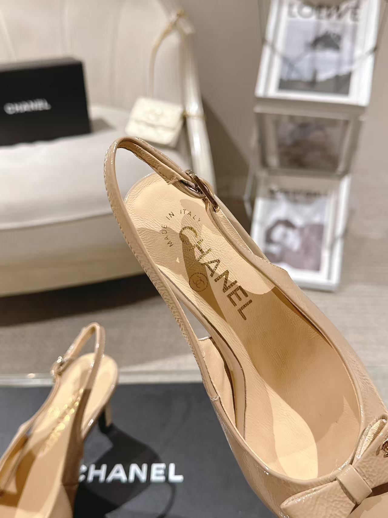 Women’s beige patent slingback pumps with pointed toe and logo-lined interior