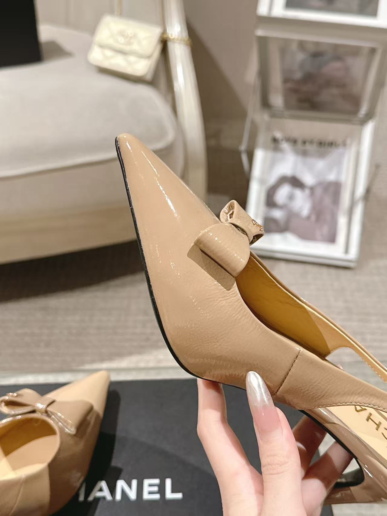 Women’s beige patent slingback pump with bow detail, pointed toe, tan insole