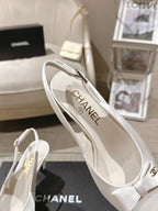 Chanel ladies white slingback pump with “CHANEL” logo on insole, angled view
