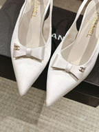 Chanel ladies white pointed-toe slingback pumps with bow, close-up pair