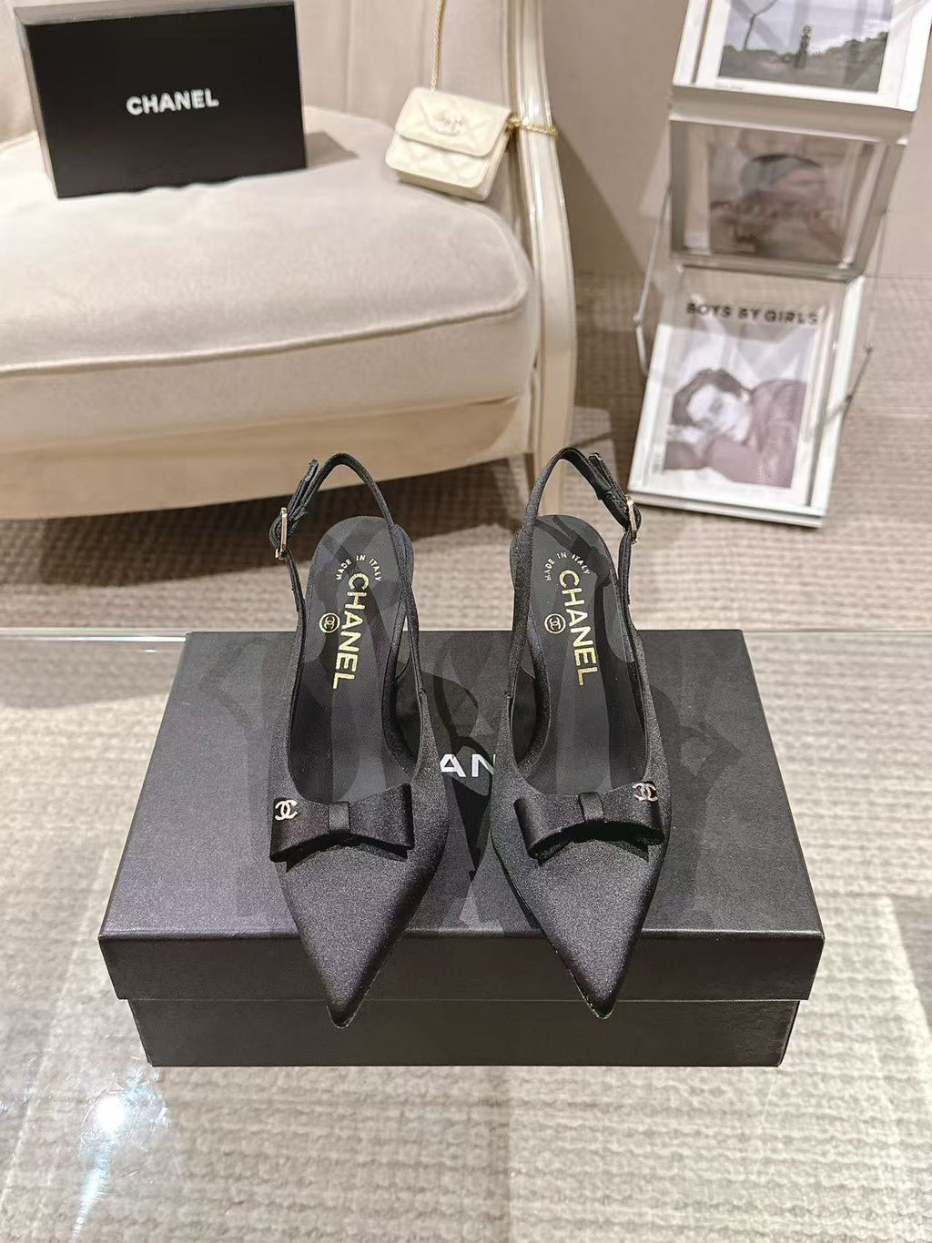 Black slingback pumps with bow detail and CHANEL logo on insole