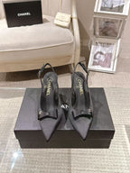 Black slingback pumps with bow detail and CHANEL logo on insole