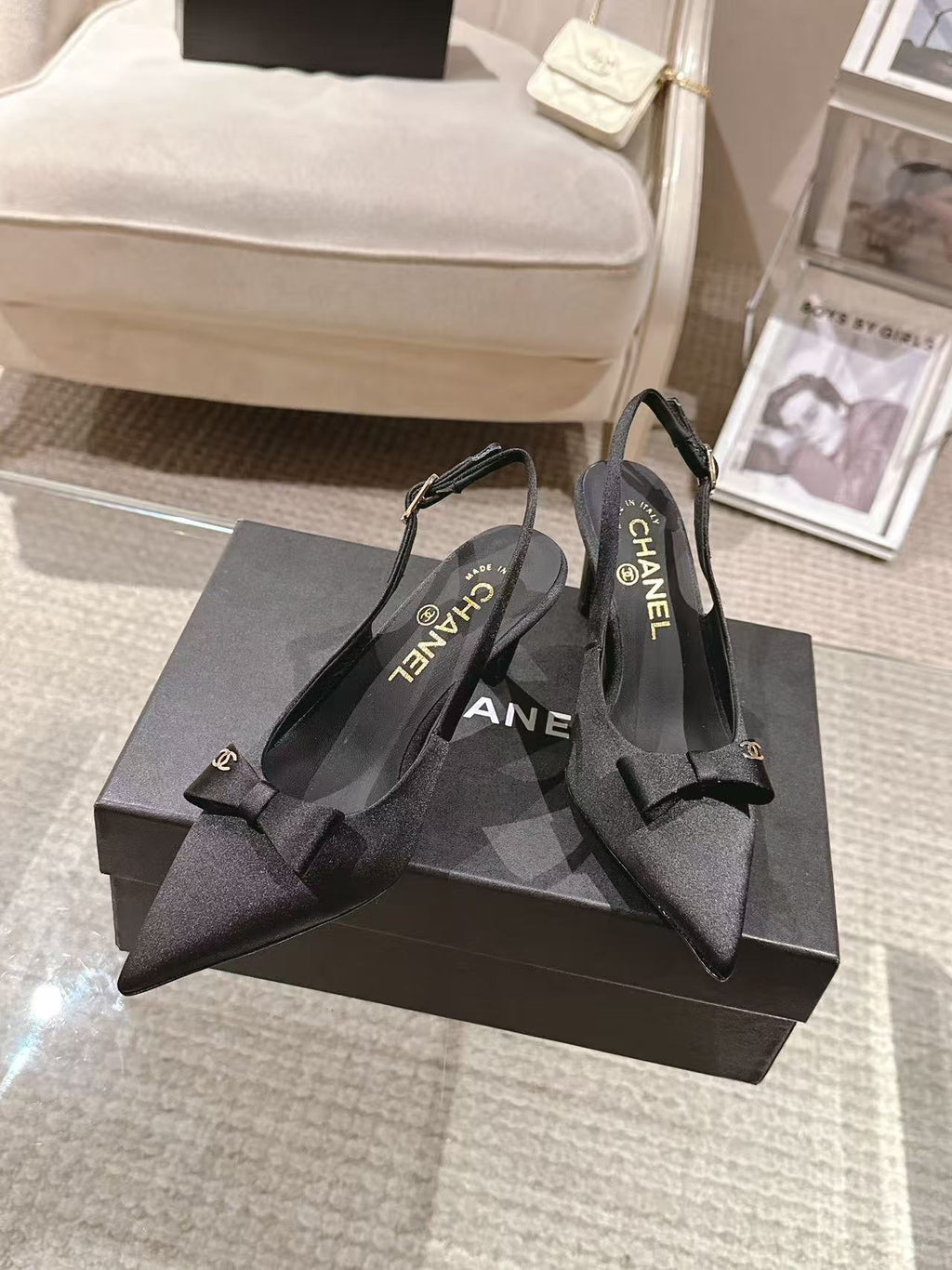 Black slingback pumps with bow at vamp and CHANEL logo on insoles