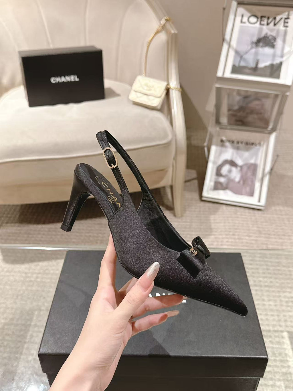 Black satin slingback pumps with pointed toe and bow strap detail