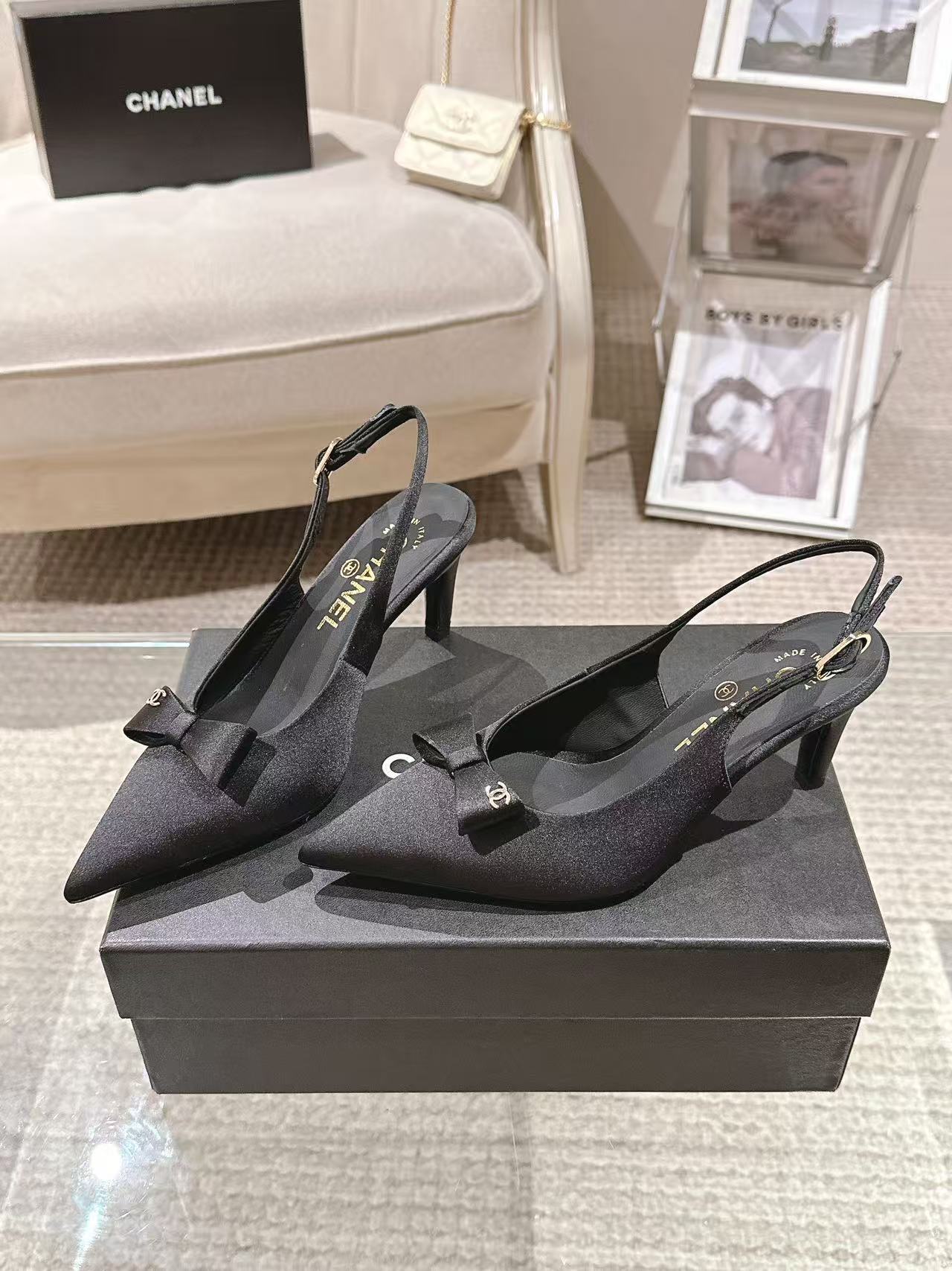 Black pointed-toe slingback pumps with bow and thin ankle strap