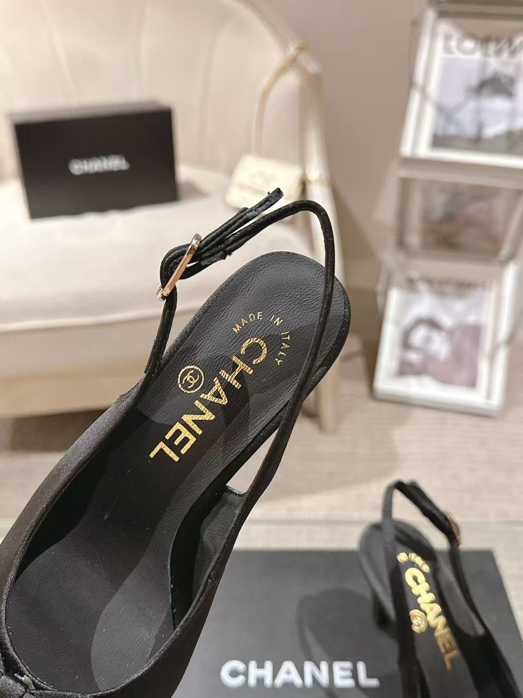 Black slingback pump showing CHANEL logo on insole and ankle strap