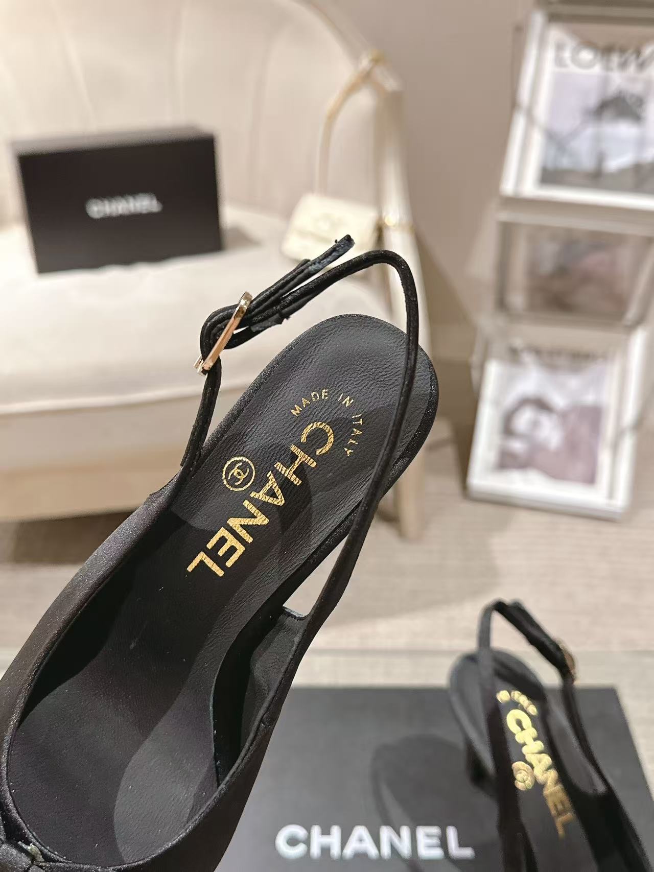 Black slingback pump showing CHANEL logo on insole and ankle strap