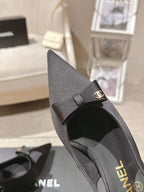 Black slingback pump side view with bow detail and CHANEL heel branding