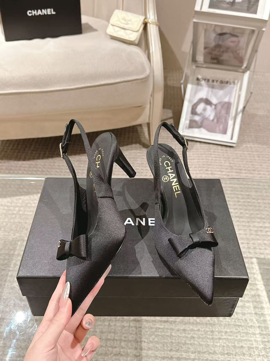 Black slingback pumps with bow detail and CHANEL logo on insoles