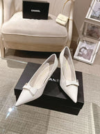 White pointed-toe slingback heels, viewed from the front with bow strap detail