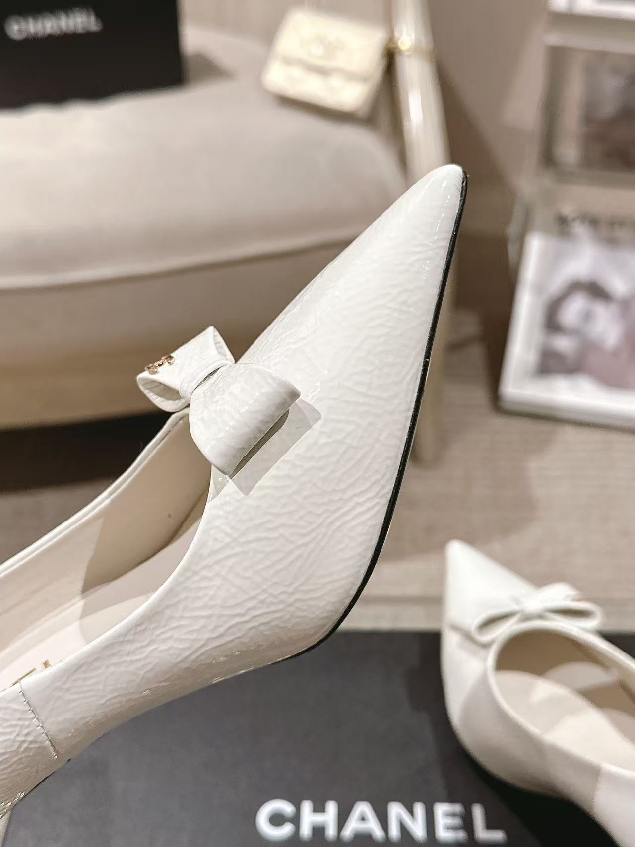 White textured slingback heel with bow strap, angled close-up view