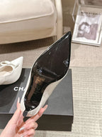Black patent leather pointed-toe slingback heel insole and logo details