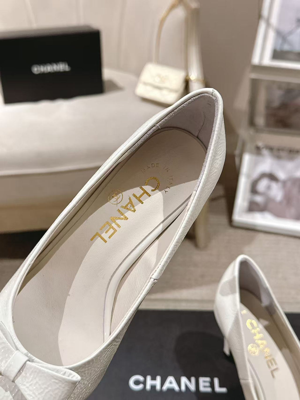 White slingback heels showing inner lining and gold lettering on the insole