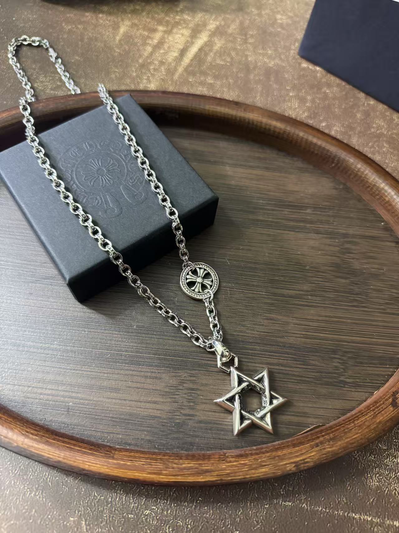 Silver-tone chain necklace with circular crest and star of David pendant
