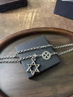 Silver-tone pendant necklace with star of David charm on long chain