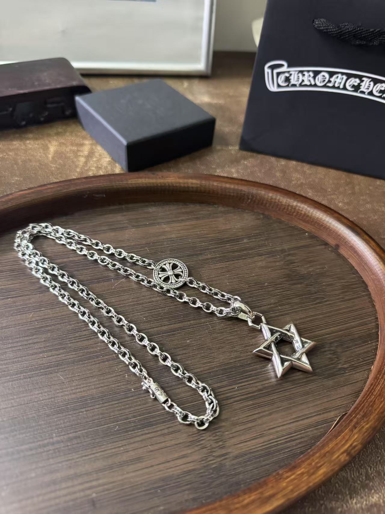 Silver-tone chain necklace with circular medallion and star of David pendant