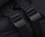 Black fabric strap buckles with embossed Louis Vuitton tabs.