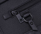 Zipper pull and leather tag with small monogram detail on black leather
