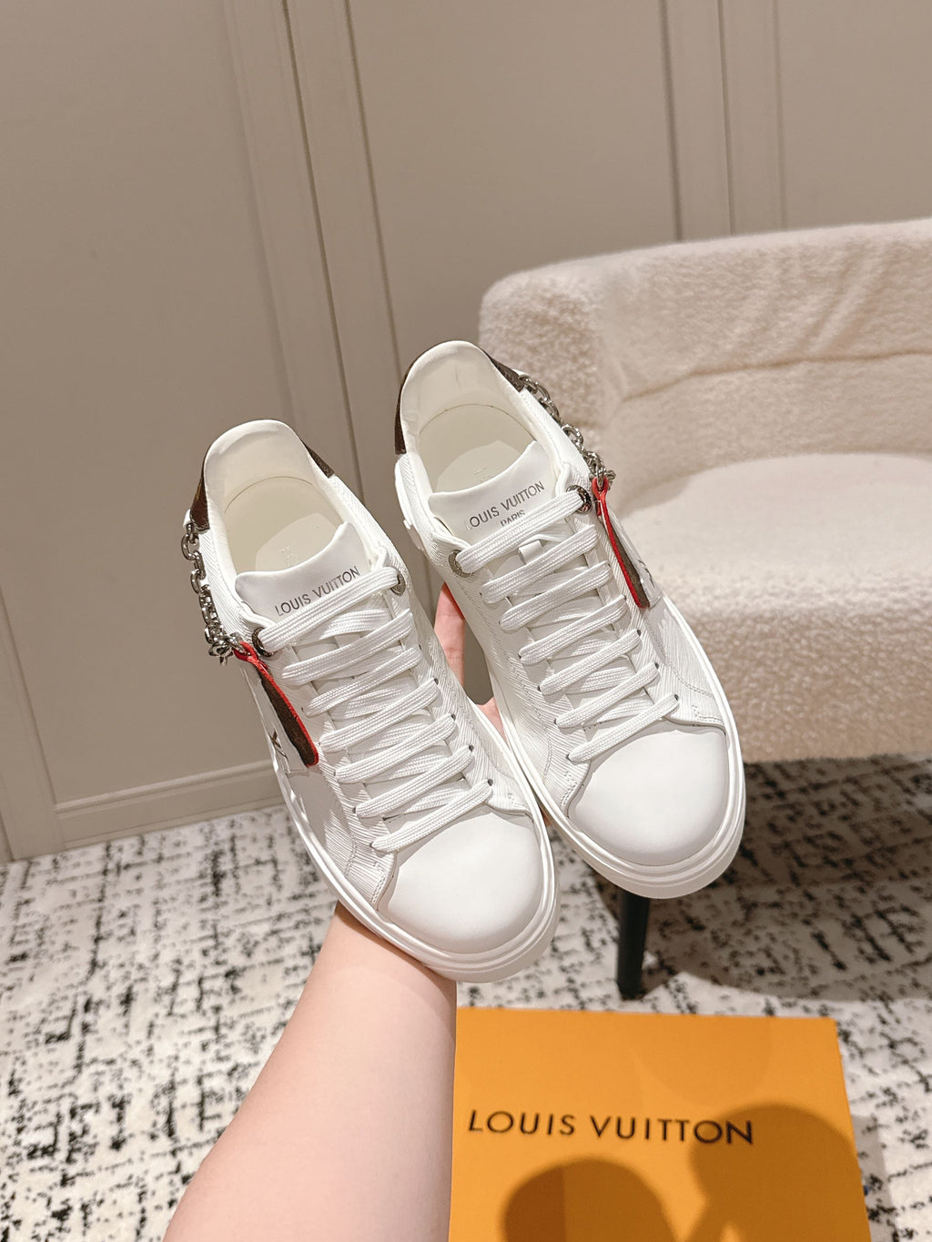 White Louis Vuitton low-top sneakers with red/green stripe and silver chain detail