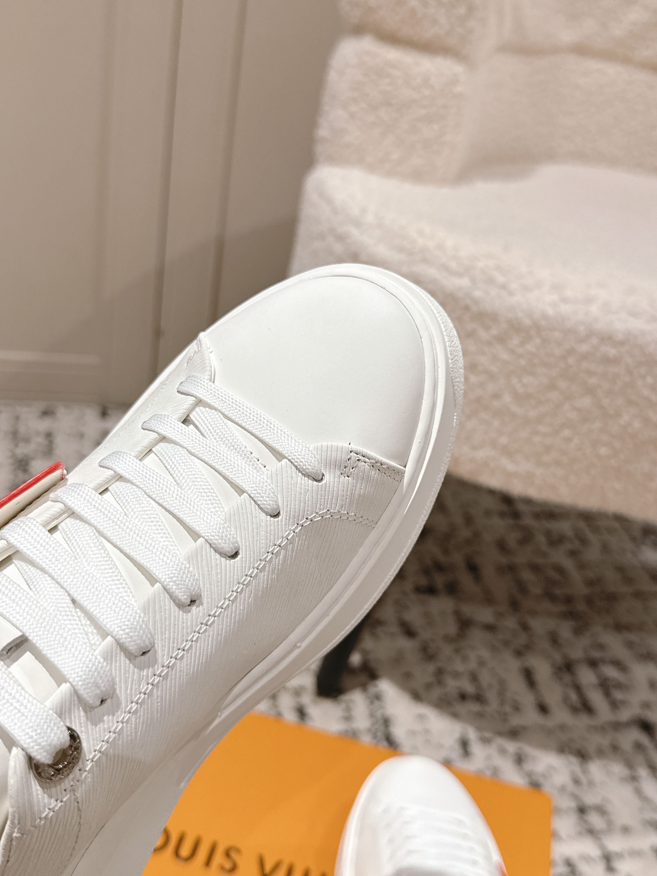 White Louis Vuitton lace-up sneaker with sculpted sole and embossed logo detail