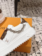 White Louis Vuitton sneaker with silver chain strap, monogram side, embossed LV sole